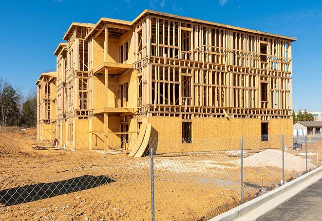 a construction site enclosed by temporary chain link fences, ensuring safety for workers and pedestrians in Hermosa Beach, CA